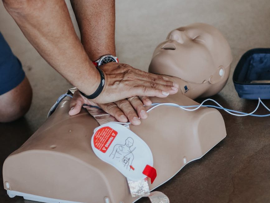 hands of person doing cpr on training dummy